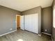Bedroom featuring a closet with sliding doors, modern flooring, and fresh neutral paint at 6725 S Winnipeg Cir # 106, Aurora, CO 80016