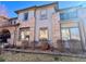 Attractive townhouse showcasing brick accents, large windows, and a charming balcony at 6725 S Winnipeg Cir # 106, Aurora, CO 80016