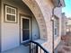 Inviting front entrance with a brick archway, screen door and manicured garden at 6725 S Winnipeg Cir # 106, Aurora, CO 80016