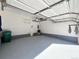 Clean, well-lit garage with a white ceiling and gray epoxy floor at 6725 S Winnipeg Cir # 106, Aurora, CO 80016