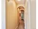 Hallway with arched doorways leading to bathroom and other rooms at 6725 S Winnipeg Cir # 106, Aurora, CO 80016