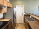 The kitchen is equipped with stainless steel appliances and leads to the outside at 6725 S Winnipeg Cir # 106, Aurora, CO 80016
