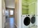 Convenient laundry area featuring modern washer and dryer, as well as shelving and storage at 6725 S Winnipeg Cir # 106, Aurora, CO 80016
