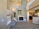 View of the living room with high ceilings, fireplace, and wood floors at 6725 S Winnipeg Cir # 106, Aurora, CO 80016
