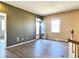 The room on the second floor has neutral paint, light wood flooring and an open doorway to an outside deck at 6725 S Winnipeg Cir # 106, Aurora, CO 80016