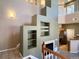 Open living room showcasing a fireplace, built-in shelving, and access to the kitchen at 6725 S Winnipeg Cir # 106, Aurora, CO 80016