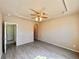 Neutral living room featuring a ceiling fan and gray wood-look flooring at 6725 S Winnipeg Cir # 106, Aurora, CO 80016