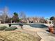 Community pool area with a cover, surrounded by seating and landscaping, providing a refreshing outdoor experience at 6725 S Winnipeg Cir # 106, Aurora, CO 80016