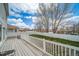 Backyard featuring a deck with white fence and lawn at 5178 Netherland St, Denver, CO 80249