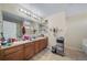 Bathroom featuring double vanity, neutral tile floors, and bright lighting at 5178 Netherland St, Denver, CO 80249
