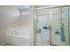 Modern bathroom with tub and shower featuring a glass door at 5178 Netherland St, Denver, CO 80249