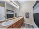 Bathroom with double sink vanity, large mirror, and neutral color palette at 5178 Netherland St, Denver, CO 80249