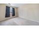 Empty bedroom with neutral carpet, window and dark curtains at 5178 Netherland St, Denver, CO 80249