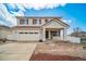 Two-story home with white siding, red shutters, covered porch and an attached two-car garage at 5178 Netherland St, Denver, CO 80249