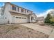 Low angle exterior of a two-story home with two-car garage and landscaped front yard at 5178 Netherland St, Denver, CO 80249
