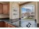Kitchen detail shows a large arched window, tiled backsplash, and cooktop at 5178 Netherland St, Denver, CO 80249