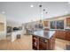 Open floor plan features a kitchen island and views to the dining and living spaces at 5178 Netherland St, Denver, CO 80249