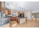 Bright kitchen featuring wood floors, an island with pendant lighting, and stainless steel appliances at 5178 Netherland St, Denver, CO 80249