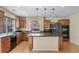 Kitchen features wood cabinets, a center island, black appliances, and durable laminate countertops at 5178 Netherland St, Denver, CO 80249