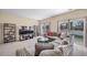 Spacious living room features large windows and a comfortable gray sectional sofa at 5178 Netherland St, Denver, CO 80249