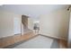 Open-concept living room with hardwood floors, a view of staircase, and connection to other living spaces at 5178 Netherland St, Denver, CO 80249
