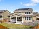 Backyard view of the house featuring solar panels and a covered deck at 6642 E 135Th Ave, Thornton, CO 80602
