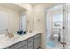 Well-lit bathroom with double sinks, light cabinetry, and shower at 6642 E 135Th Ave, Thornton, CO 80602