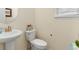 Powder room with pedestal sink, toilet, neutral walls and decor at 6642 E 135Th Ave, Thornton, CO 80602