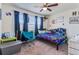 Bedroom with window, carpet, fan, and blue curtains at 6642 E 135Th Ave, Thornton, CO 80602
