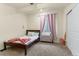 Cozy bedroom with neutral carpet, twin bed, and light pink curtains at 6642 E 135Th Ave, Thornton, CO 80602