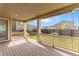 Relaxing covered deck with wood railing, perfect for outdoor entertaining and enjoying the backyard at 6642 E 135Th Ave, Thornton, CO 80602