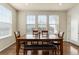 Bright dining room with hardwood floors, large window, and wooden table at 6642 E 135Th Ave, Thornton, CO 80602