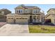Beautiful two-story home boasts a three-car garage and a welcoming front porch at 6642 E 135Th Ave, Thornton, CO 80602