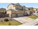 Attractive two-story home featuring a three-car garage, manicured lawn, and welcoming front porch at 6642 E 135Th Ave, Thornton, CO 80602