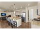 Open concept kitchen with granite island, stainless appliances, and hardwood floors at 6642 E 135Th Ave, Thornton, CO 80602