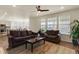 Open-concept living room adjacent to the kitchen, featuring hardwood floors and bright windows at 6642 E 135Th Ave, Thornton, CO 80602