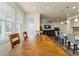 View from the dining room to the living room and kitchen with hardwood floors at 6642 E 135Th Ave, Thornton, CO 80602