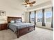 Spacious main bedroom with tray ceilings, fan, windows, and decor at 6642 E 135Th Ave, Thornton, CO 80602