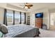 Large primary suite with ceiling fan, TV, and many windows at 6642 E 135Th Ave, Thornton, CO 80602