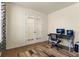 Home office with hardwood floors, neutral walls, and double french doors at 6642 E 135Th Ave, Thornton, CO 80602