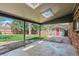 Covered back patio with skylights, overlooking a green backyard with mature trees and a shed at 7521 S Race St, Centennial, CO 80122