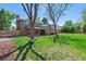 Spacious backyard with a shed, patio, and lush lawn, perfect for outdoor living at 7521 S Race St, Centennial, CO 80122