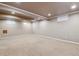 Spacious basement with neutral carpet and walls, offering versatile living space at 7521 S Race St, Centennial, CO 80122