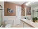 Bathroom featuring wainscotting, a glass shower and a functional vanity at 7521 S Race St, Centennial, CO 80122