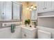 Neutral bathroom features wainscotting, window, and storage at 7521 S Race St, Centennial, CO 80122