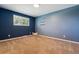 Cozy bedroom featuring a wall with three shelves and a large window for natural light at 7521 S Race St, Centennial, CO 80122