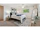 Cozy bedroom featuring a comfortable bed, ceiling fan and a large window for natural light at 7521 S Race St, Centennial, CO 80122