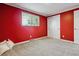 Bedroom featuring red walls, a closet and a large window for natural light at 7521 S Race St, Centennial, CO 80122