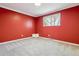 Bedroom featuring red walls and a large window for natural light at 7521 S Race St, Centennial, CO 80122