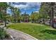 Inviting community green space featuring a walking path, mature trees, and landscaping, perfect for relaxing outdoors at 7521 S Race St, Centennial, CO 80122